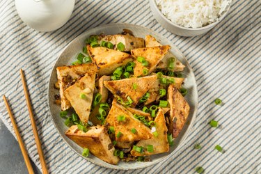 Bowl of tofu on striped background