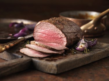 Sliced chateaubriand steak on a cutting board, as an example of red meat that might give you diarrhea