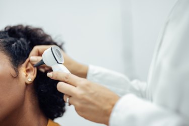 Close up of person getting an ear exam at the doctor