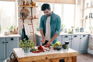man preparing a plant-based recipe from the best vegetarian cookbooks