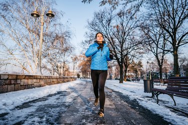 Athlete running in cold weather wearing cold weather runing gear.