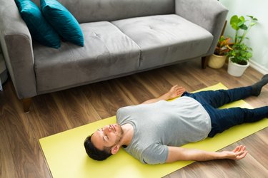person doing savasana yoga exercise for occipital pain