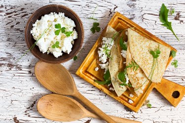 Crepes with arugula and farmer cheese viewed from above