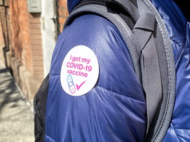 Person with "I got my COVID-19 vaccine" sticker