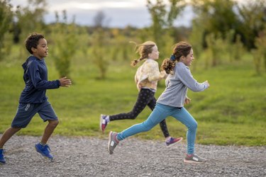 Young Woman With A Sporty Outfit Operates Jogging In The Nature