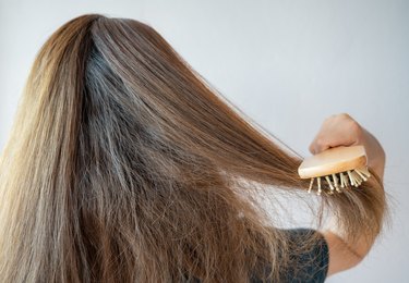 Rear view of a person brushing their dry hair