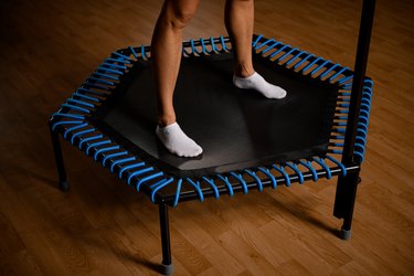 Close up of adult legs on exercise trampoline.