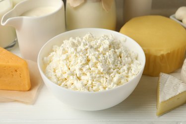 Different fresh dairy products on white wooden table