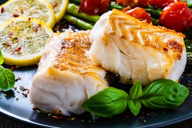 Baked ocean perch fillet with vegetables on plate