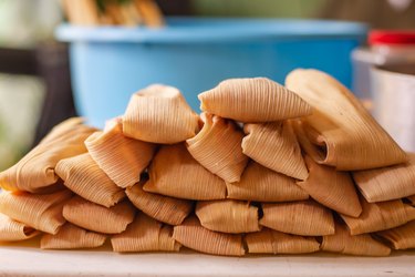 Delicious traditional Mexican tamales piled on a table