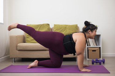 Person doing yoga inside following best exercise tips for plus-size athletes