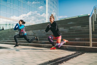 women doing bulgarian split squats on outdoor stairs