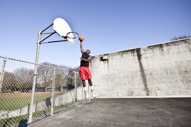 African American man playing basketball, working on his vertical jump