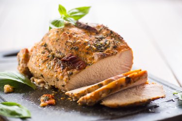 Pre-cooked Turkey Breast Roasted With Herb Seasoning on a Slate Cutting Board