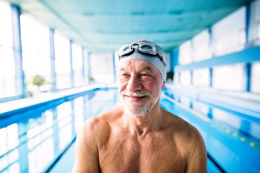 Senior man in an indoor swimming pool.