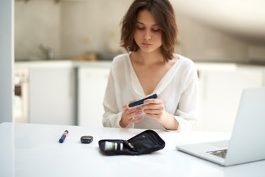 Young woman taking blood sugar test