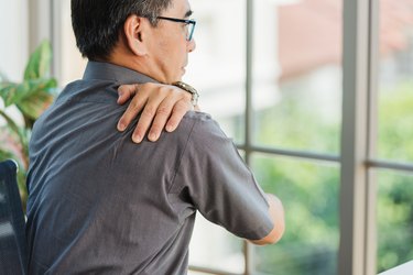 person working with laptop computer with back pain