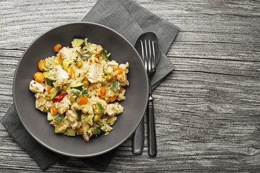 Chicken and rice from a slow cooker on a grey wooden table