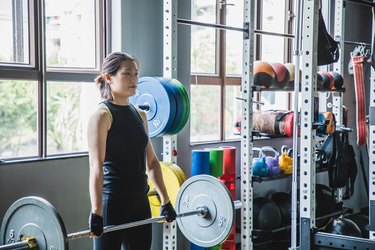 Person performing a deadlift in the gym for a lower-body workout