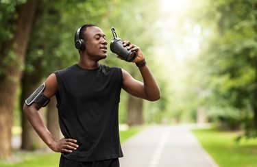 A man drinking apple cider vinegar pre-workout for muscle cramps