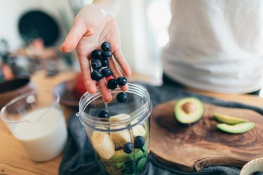 close view of a person making a fruit smoothie