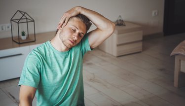 Man stretching his neck muscles. Morning workout. Healthcare