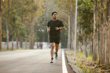Person running outside on road to show how fast you lose cardio fitness.