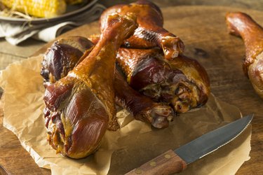Barbecue Smoked Turkey Leg on parchment paper on wooden table