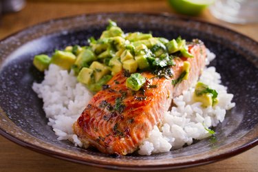 Salmon fillet with avocado lime coriander salsa, rice as a garnish