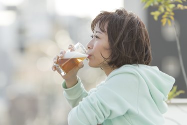 person sipping a beer, which you can't drink before a colonoscopy