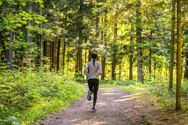 Person running on footpath outdoors demonstrating how to increase speed in cross-country running.