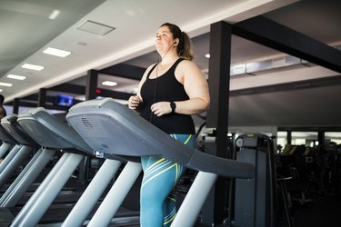 Person walking on a treadmill at the gym to represent doing the 12-3-30 workout