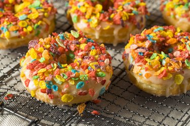 Gourmet homemade donuts with colorful fruit flakes on top.