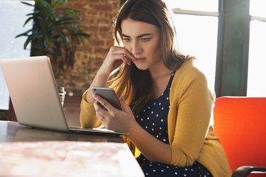 woman at work distracted by her phone