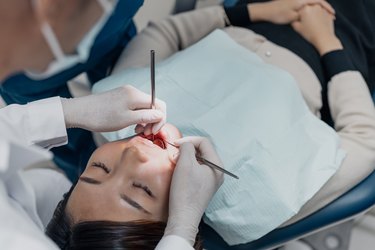 A dental patient being examined and treated by a dentist