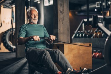 Active older adult doing a workout on a rowing machine, one of the best exercise machines for older adults