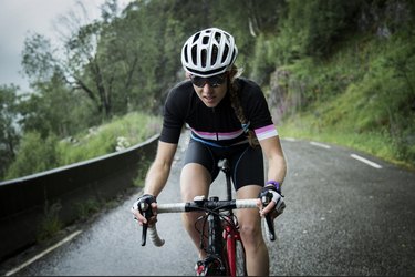 female race cyclist riding on a mountain road