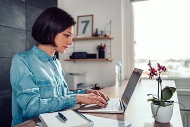 Woman sitting up straight while working and wearing a posture corrector