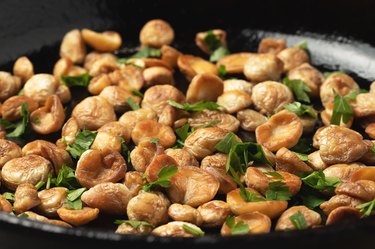 a closeup photo of cooking edible puffball mushrooms by frying in a pan