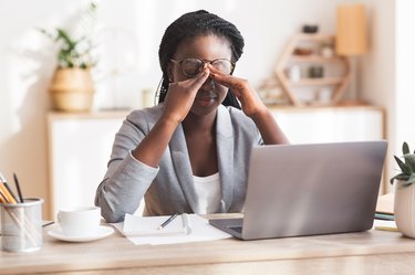 woman working at home and rubbing her eyes because she can't focus