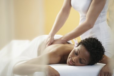 Woman receiving deep tissue massage at a spa