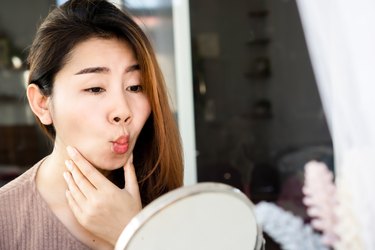 Asian woman doing face yoga , exercises for anti-aging, slimming face