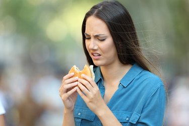 A woman eating food that suddenly tastes different