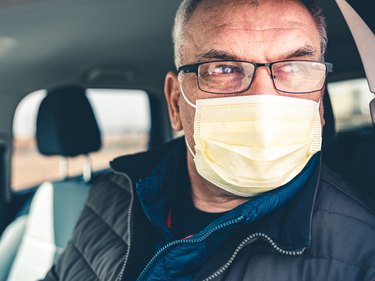 COVID-19, Mature man wearing disposable face mask and eyeglasses