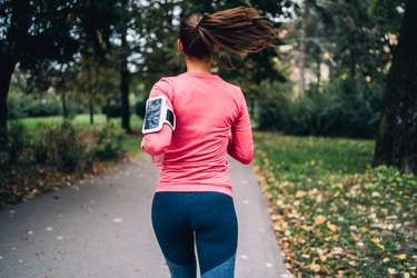 Woman jogging in public park.