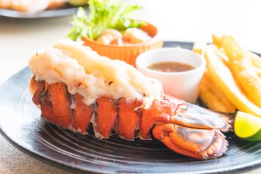 Close-up of fully-cooked lobster tail in plate on table