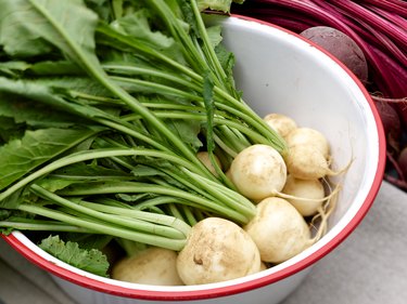 Fresh white beets in rustic metal bowl