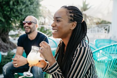 Young woman enjoying a mocktail with friends