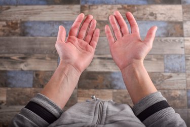 Two hands held up with their palms facing opposite directions