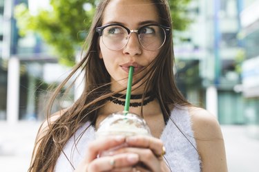 Picture of a girl drinking milkshake, a food that's bad for skin